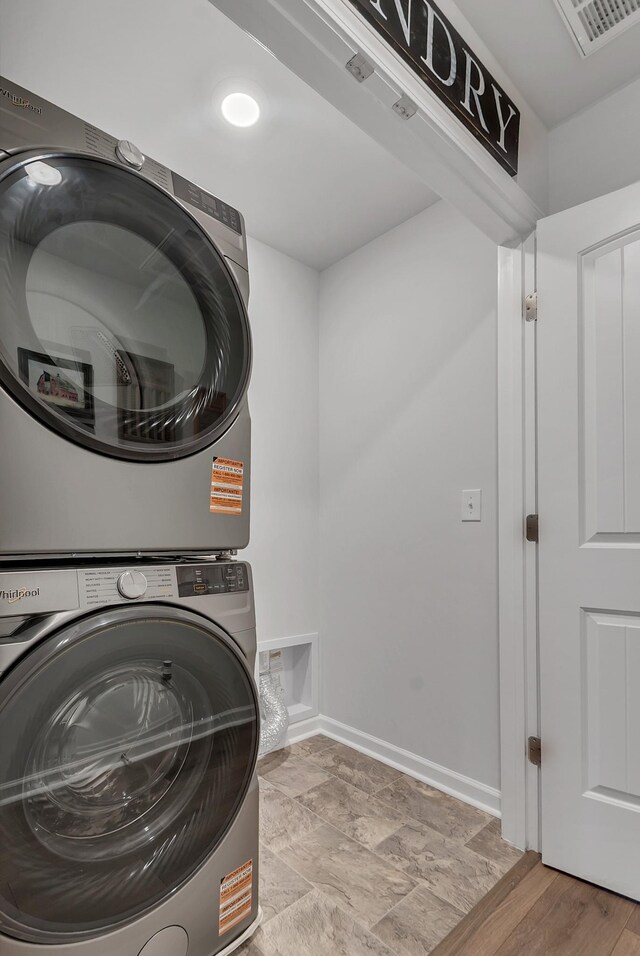 803 Dallas Dr, Columbia, TN 38401 - laundry area featuring stacked washer and clothes dryer and baseboards