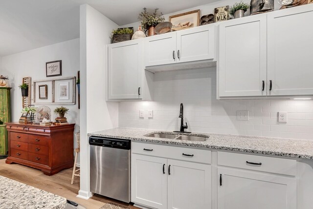 803 Dallas Dr, Columbia, TN 38401 - kitchen with stainless steel dishwasher, a sink, light wood-style flooring, and backsplash