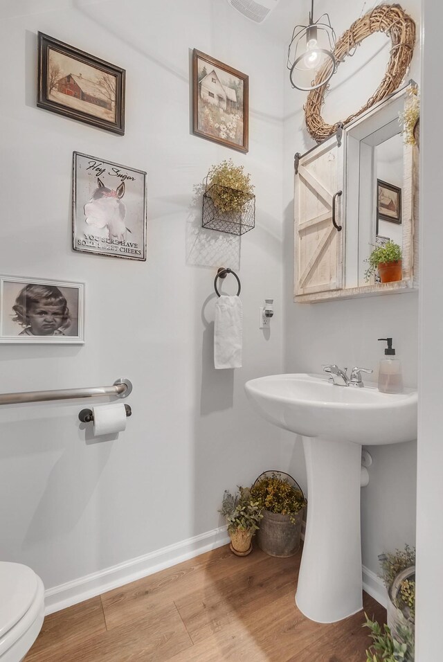 803 Dallas Dr, Columbia, TN 38401 - half bath with toilet, wood finished floors, baseboards, and a sink
