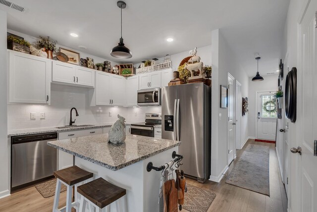 803 Dallas Dr, Columbia, TN 38401 - kitchen with appliances with stainless steel finishes, a sink, light wood-style floors, backsplash, and recessed lighting