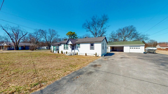 121 Highland St, La Vergne, TN 37086 - view of front of house featuring a garage, a front yard, and metal roof