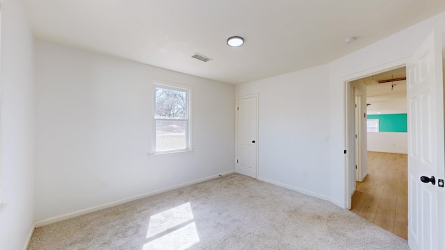 121 Highland St, La Vergne, TN 37086 - unfurnished bedroom with multiple windows, attic access, light carpet, and baseboards
