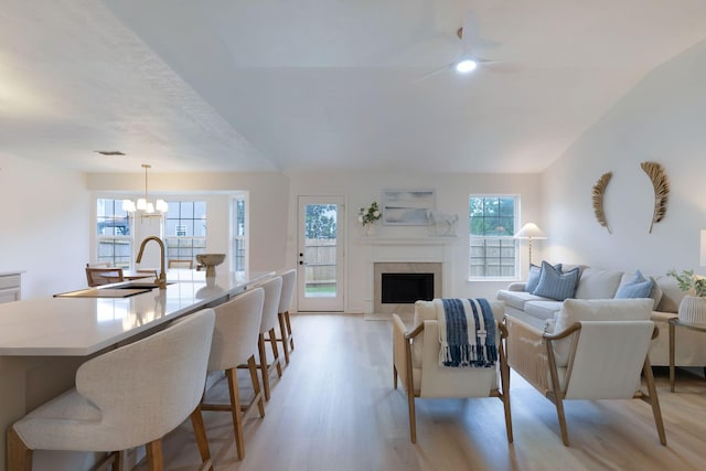 3755 Indian Creek Blvd, Murfreesboro, TN 37128 - living room featuring light wood finished floors, ceiling fan, a chandelier, and a fireplace