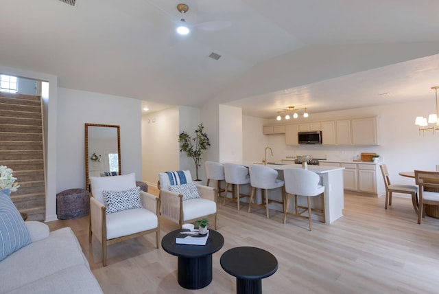 3755 Indian Creek Blvd, Murfreesboro, TN 37128 - living area featuring stairs, light wood-style floors, lofted ceiling, a chandelier, and a ceiling fan
