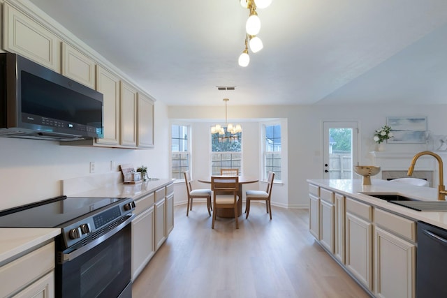 3755 Indian Creek Blvd, Murfreesboro, TN 37128 - kitchen with stainless steel electric stove, dishwashing machine, a sink, a chandelier, and light wood-style flooring