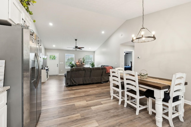 125 Vivian Ln, Carthage, TN 37030 - dining area featuring a chandelier, light wood finished floors, lofted ceiling, ceiling fan, and baseboards