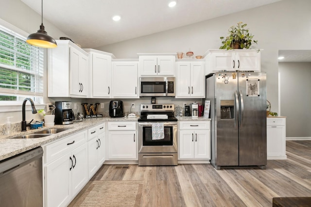 125 Vivian Ln, Carthage, TN 37030 - kitchen featuring appliances with stainless steel finishes, a sink, vaulted ceiling, light wood finished floors, and white cabinets