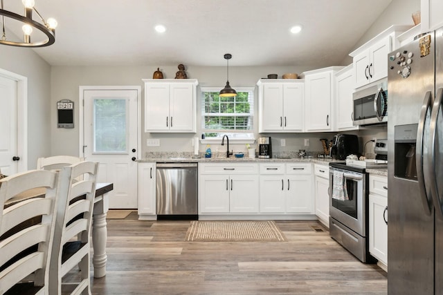 125 Vivian Ln, Carthage, TN 37030 - kitchen featuring appliances with stainless steel finishes, a sink, white cabinets, a chandelier, and recessed lighting