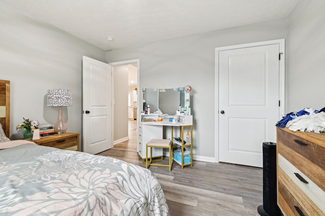 125 Vivian Ln, Carthage, TN 37030 - bedroom featuring wood finished floors, a textured ceiling, and baseboards