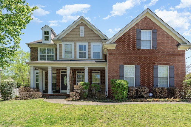 1033 Wyntergrace Farm Rd, Old Hickory, TN 37138 - view of front of house with covered porch, a front yard, and brick siding