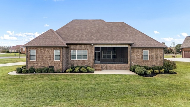 103 Rosehaven Ct, Tullahoma, TN 37388 - back of property with brick siding, a sunroom, a yard, and roof with shingles
