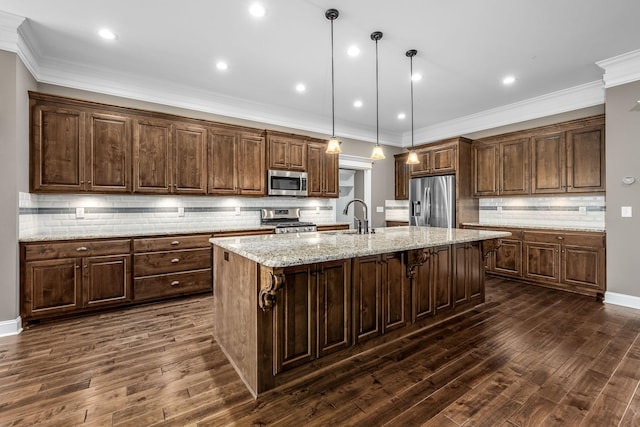 103 Rosehaven Ct, Tullahoma, TN 37388 - kitchen featuring appliances with stainless steel finishes, backsplash, a kitchen island with sink, dark wood finished floors, and crown molding