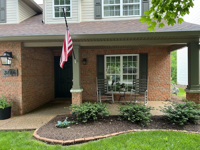 3176 Tristan Dr, Franklin, TN 37064 - property entrance with a porch, brick siding, and a shingled roof