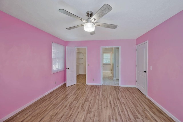 4905 Algonquin Trl, Antioch, TN 37013 - unfurnished bedroom featuring light wood-style flooring, baseboards, a walk in closet, a closet, and ceiling fan