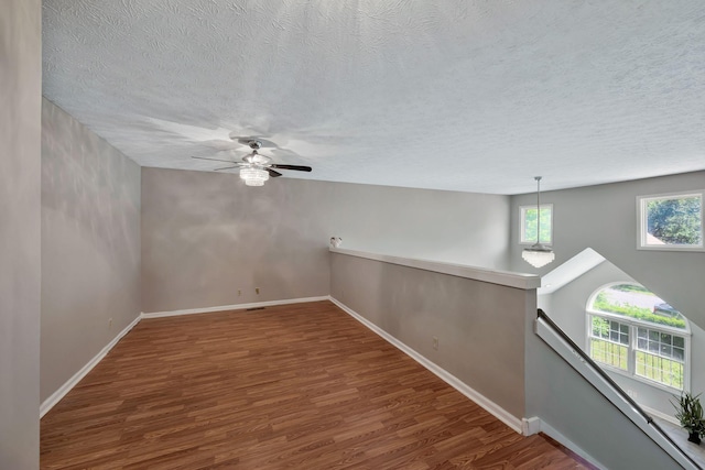 4905 Algonquin Trl, Antioch, TN 37013 - unfurnished room featuring wood finished floors, a textured ceiling, baseboards, and a ceiling fan