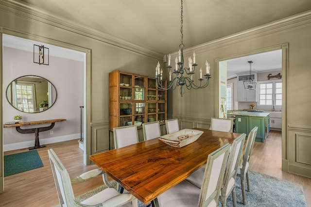 1422 Primrose Ln, Franklin, TN 37064 - dining room featuring a chandelier, crown molding, and light wood-style flooring