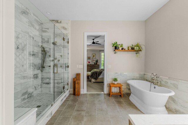 1422 Primrose Ln, Franklin, TN 37064 - ensuite bathroom with a soaking tub, a stall shower, tile walls, a ceiling fan, and a wainscoted wall