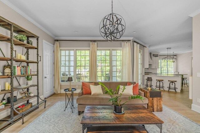 1422 Primrose Ln, Franklin, TN 37064 - living room with a chandelier, light wood-style floors, baseboards, and crown molding