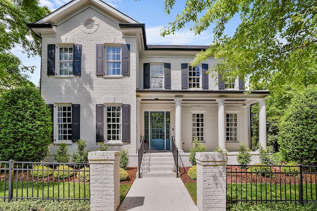 1422 Primrose Ln, Franklin, TN 37064 - view of front of house featuring a porch, brick siding, and a fenced front yard
