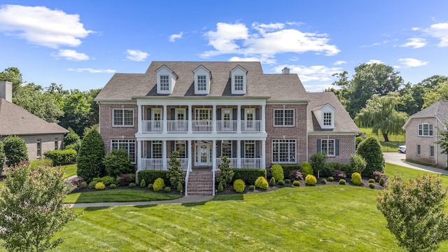 9166 Sydney Ln, Brentwood, TN 37027 - view of front of house with a porch, brick siding, and a front lawn