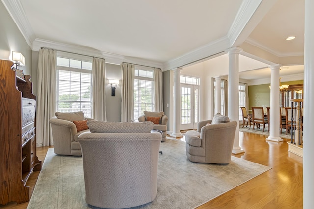 9166 Sydney Ln, Brentwood, TN 37027 - living room featuring decorative columns, crown molding, wood finished floors, and recessed lighting