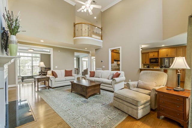 9166 Sydney Ln, Brentwood, TN 37027 - living room with a ceiling fan, ornamental molding, light wood finished floors, recessed lighting, and a high ceiling