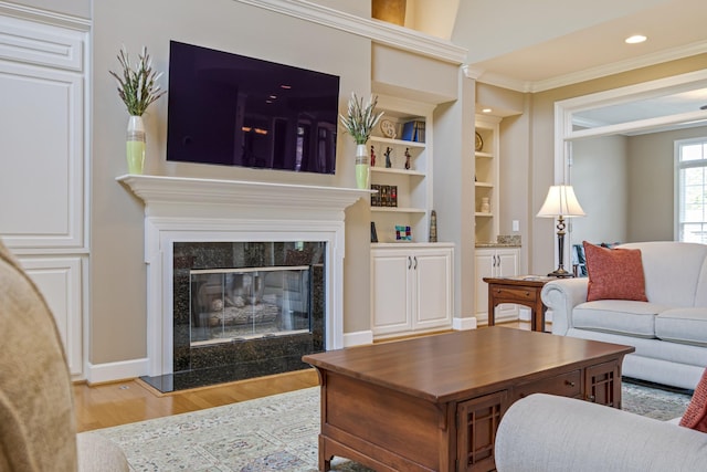 9166 Sydney Ln, Brentwood, TN 37027 - living area with ornamental molding, light wood-style flooring, a high end fireplace, built in features, and recessed lighting