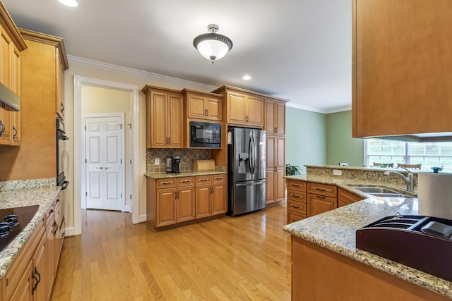 9166 Sydney Ln, Brentwood, TN 37027 - kitchen with black appliances, a sink, crown molding, light wood-type flooring, and brown cabinets