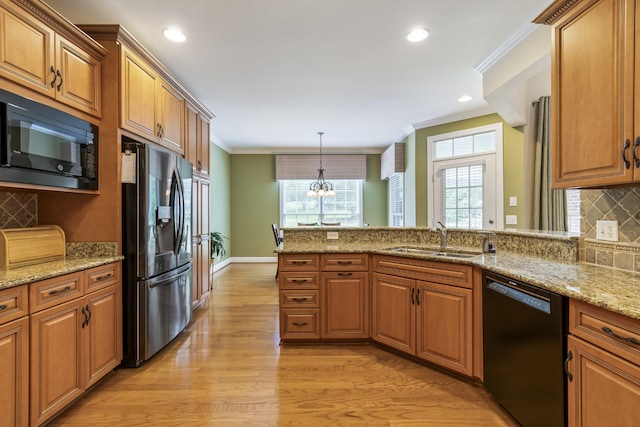 9166 Sydney Ln, Brentwood, TN 37027 - kitchen featuring black appliances, a sink, light wood-style flooring, ornamental molding, and a chandelier