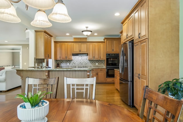 9166 Sydney Ln, Brentwood, TN 37027 - kitchen with freestanding refrigerator, ornamental molding, a peninsula, tasteful backsplash, and light wood-style flooring