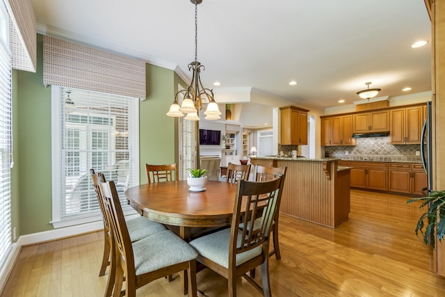 9166 Sydney Ln, Brentwood, TN 37027 - dining area with crown molding, light wood finished floors, baseboards, recessed lighting, and a chandelier