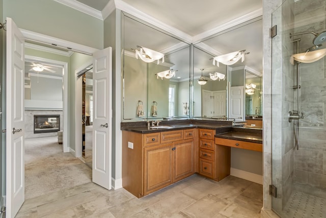 9166 Sydney Ln, Brentwood, TN 37027 - bathroom with ornamental molding, a shower stall, vanity, a glass covered fireplace, and ceiling fan