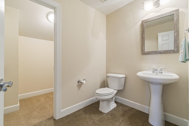 9166 Sydney Ln, Brentwood, TN 37027 - bathroom with toilet, tile patterned flooring, baseboards, and a sink