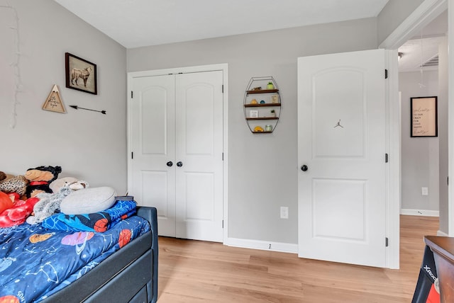 241 Holly Grove Rd, Lewisburg, TN 37091 - bedroom with light wood finished floors, a closet, and baseboards