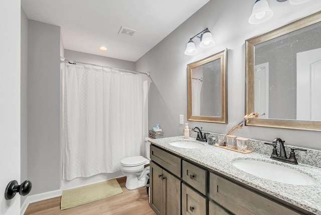 241 Holly Grove Rd, Lewisburg, TN 37091 - bathroom featuring toilet, double vanity, wood finished floors, and shower / bath combo