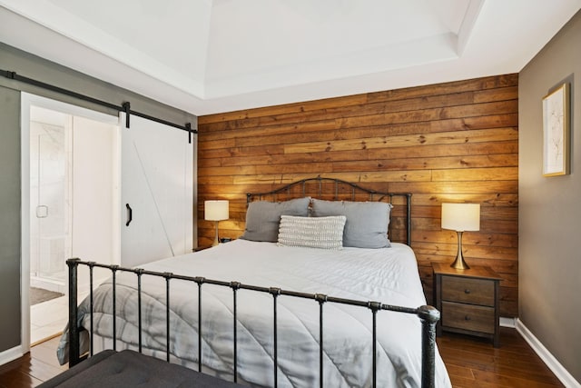 2754 Douglas Ln, Thompsons Station, TN 37179 - bedroom with wood walls, wood finished floors, baseboards, a barn door, and a raised ceiling