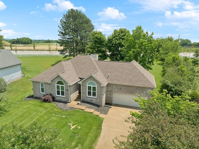 2754 Douglas Ln, Thompsons Station, TN 37179 - single story home featuring a shingled roof, an attached garage, concrete driveway, brick siding, and a view of rural / pastoral area