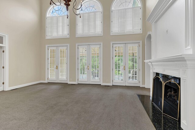 113 Middleton Cir, Nashville, TN 37215 - unfurnished living room featuring dark colored carpet, a towering ceiling, a premium fireplace, french doors, and baseboards
