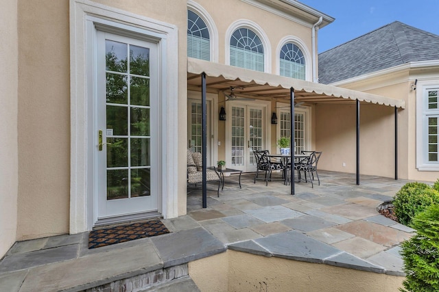 113 Middleton Cir, Nashville, TN 37215 - entrance to property featuring french doors, stucco siding, a patio area, outdoor dining space, and a shingled roof
