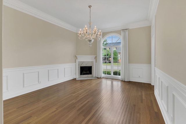 113 Middleton Cir, Nashville, TN 37215 - unfurnished living room with a chandelier, dark wood-style flooring, a wainscoted wall, crown molding, and a high end fireplace