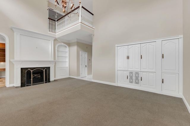 113 Middleton Cir, Nashville, TN 37215 - unfurnished living room with a towering ceiling, carpet flooring, a chandelier, baseboards, and a high end fireplace