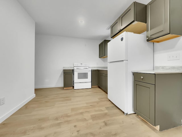 109 Daniel St, Waverly, TN 37185 - kitchen with white appliances, light wood-style floors, baseboards, and light countertops