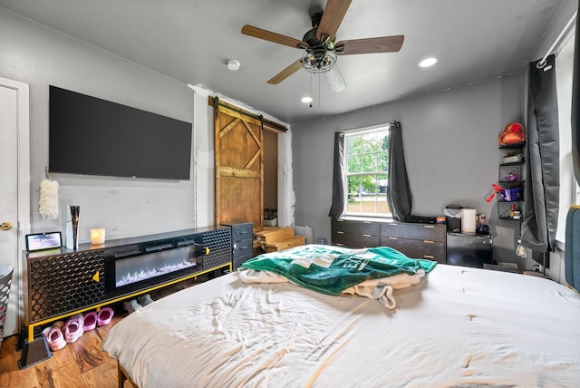 525 Inver Ln, Clarksville, TN 37042 - bedroom featuring a barn door, wood finished floors, recessed lighting, and a ceiling fan