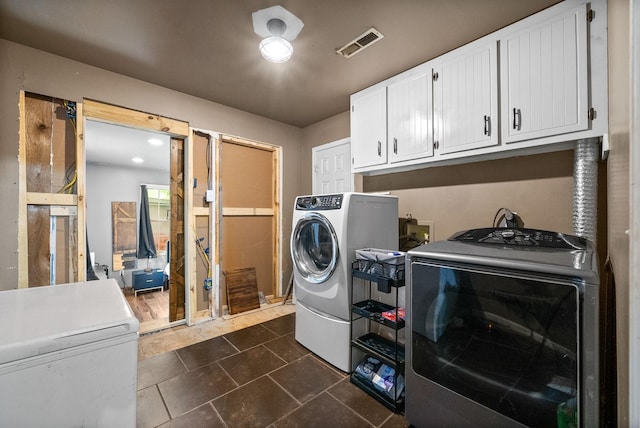 525 Inver Ln, Clarksville, TN 37042 - laundry area featuring washing machine and clothes dryer, cabinet space, and dark tile patterned flooring