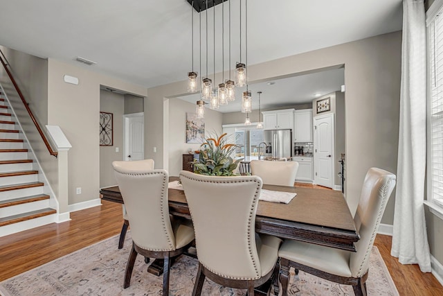 5190 Giardino Dr, Mount Juliet, TN 37122 - dining area featuring stairway, light wood-style flooring, and baseboards