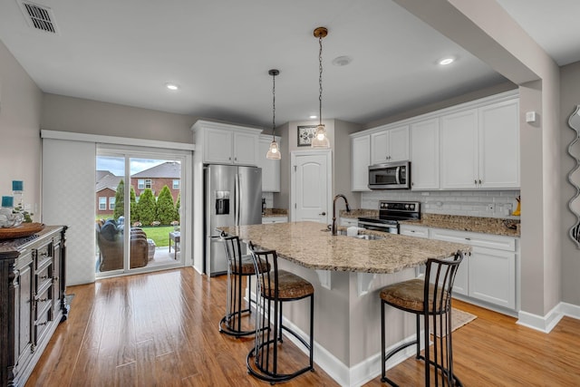 5190 Giardino Dr, Mount Juliet, TN 37122 - kitchen with stainless steel appliances, a sink, light wood-type flooring, a breakfast bar, and recessed lighting