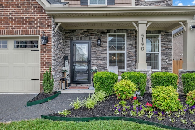 5190 Giardino Dr, Mount Juliet, TN 37122 - property entrance featuring a porch, a garage, and stone siding