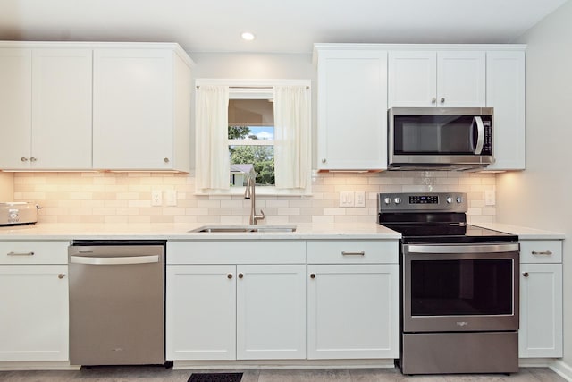 600 Riverview Dr, Franklin, TN 37064 - kitchen featuring stainless steel appliances, a sink, white cabinets, and recessed lighting