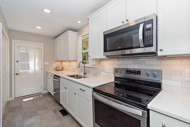 600 Riverview Dr, Franklin, TN 37064 - kitchen featuring stainless steel appliances, a sink, white cabinetry, recessed lighting, and decorative backsplash