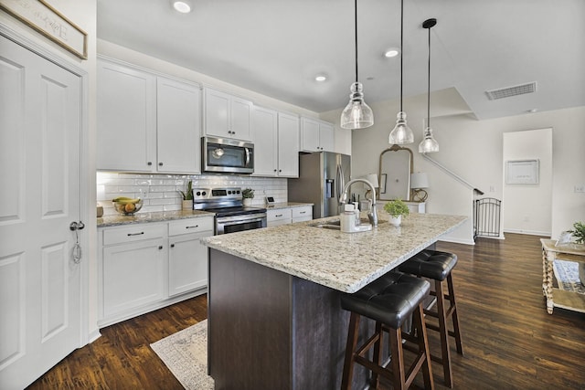 6013 Doster Rd, Smyrna, TN 37167 - kitchen featuring stainless steel appliances, a sink, an island with sink, dark wood-type flooring, and white cabinets